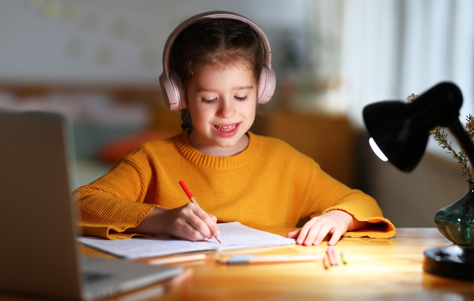 Little kid studying online at home